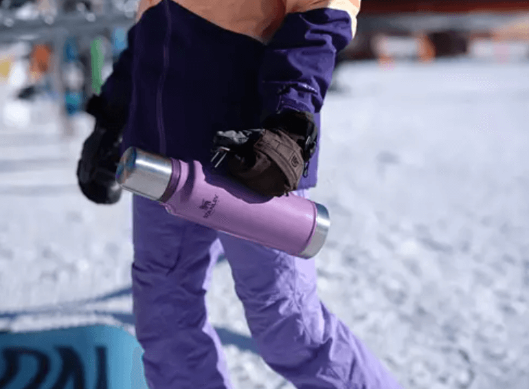 insulated thermos person carrying - cold weather camping essentials